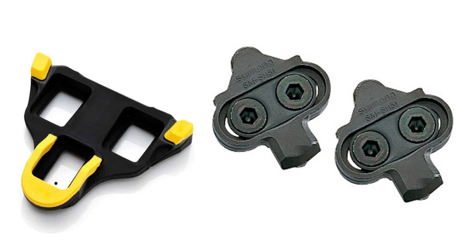 Examples of shoe cleats fixed to the underside of cycling shoes SPD-SL (in yellow) usually found on road bikes and SPD (all black) often used for mountain bikes.