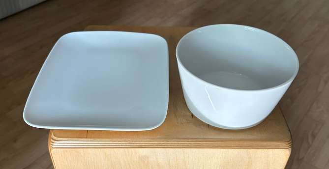 A white rectangular plate with rounded corners and a white round bowl.