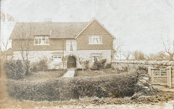 Old sepia postcard of farmhouse in Somerset