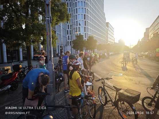 Die Raddemo im Sonnenuntergang stellt sich in der Kantstr. auf, um der Lastenradschau beizuwohnen.