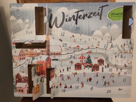 Picture of a German advent calendar that has multiple little doors already opened
 The cardboard calender is called Winterzeit with a visual of a Christmas market in a snowy landscape