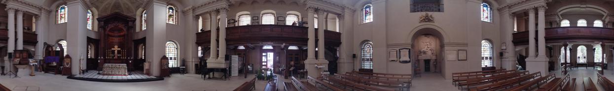 A panorama of the nave of a square church.
