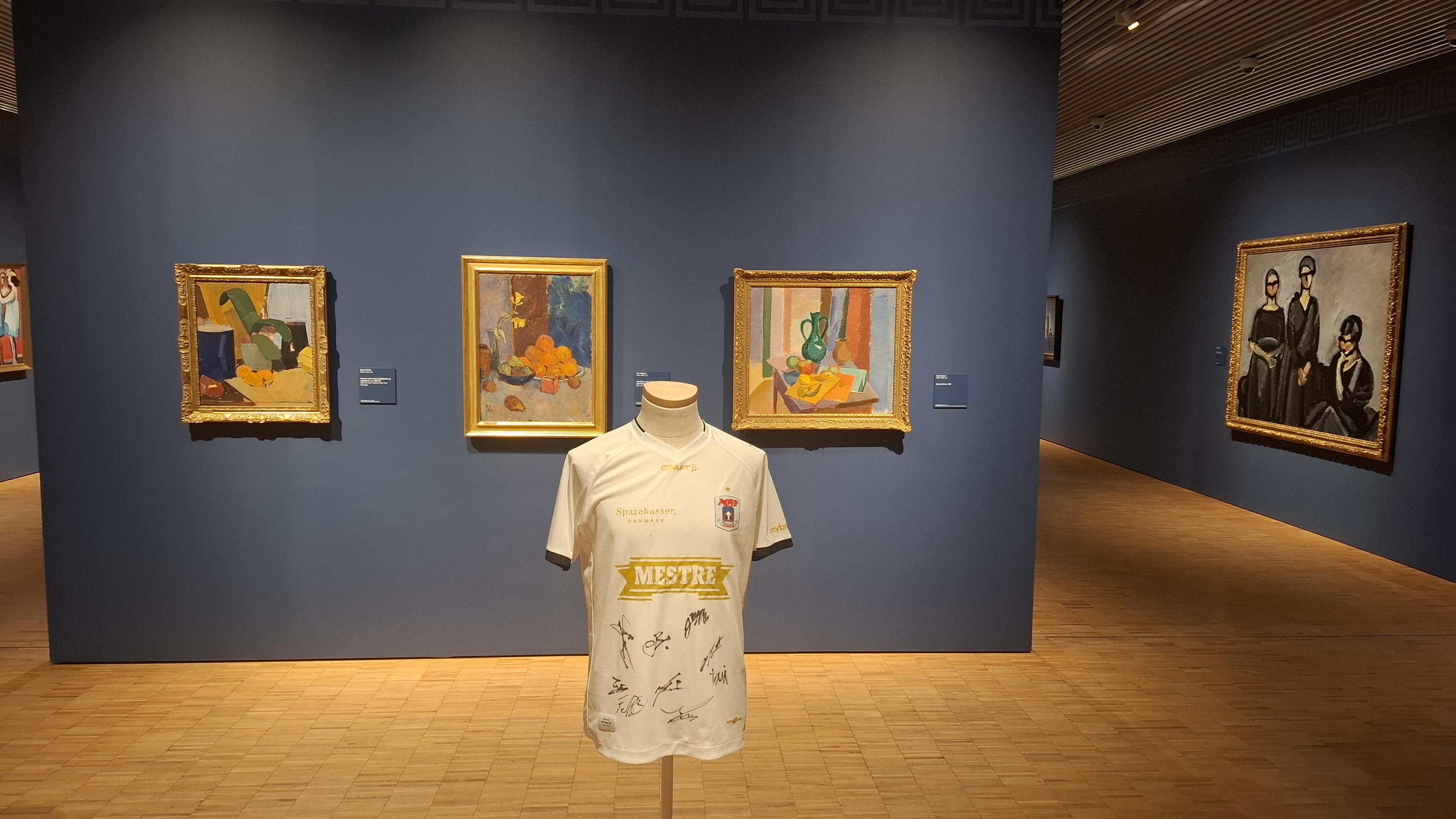 Close-up of signed AGF football shirt in art museum. Fuller description in first photo Alt Text